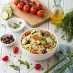 Greek chicken orzo salad in a large bowl with vegetables
